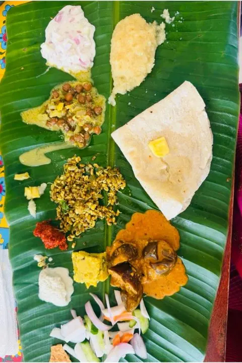 Chapatti with butter, curries and chutneys served on a banana leaf on a Mysore food walk
