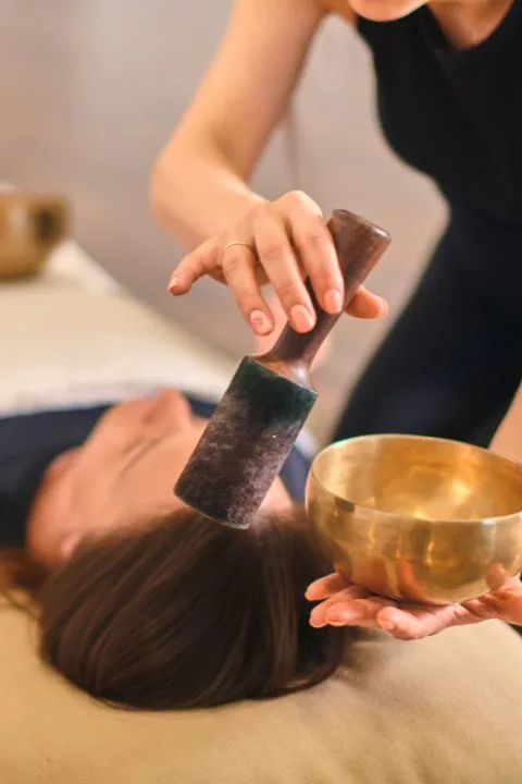 Singing bowl being played during a sound healing session in Mysore