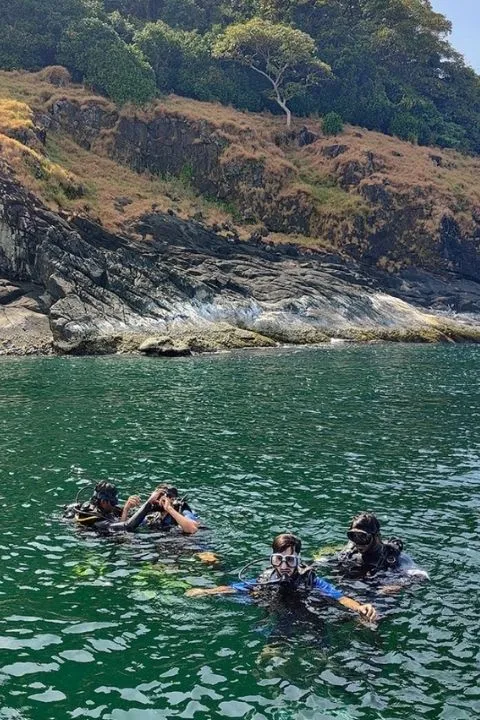 Scuba divers entering the ocean from a boat