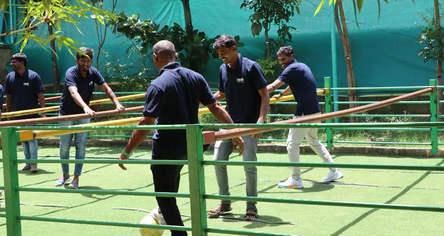 Corporate team playing human foosball