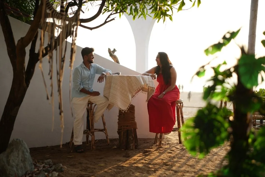 Couple relaxing at a beachside seating area in Gokarna
