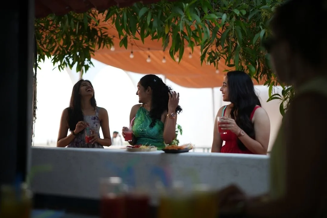 Guests enjoying drinks at an outdoor beachside café in Gokarna