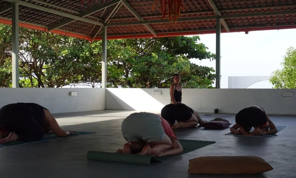 Yoga session at Borrbo Gokarna in an open beachside shala