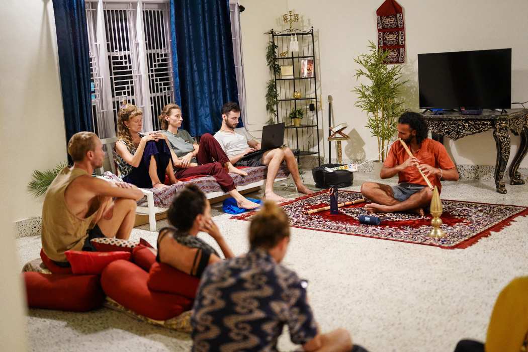 Backpackers enjoying a flute jam session in the common room