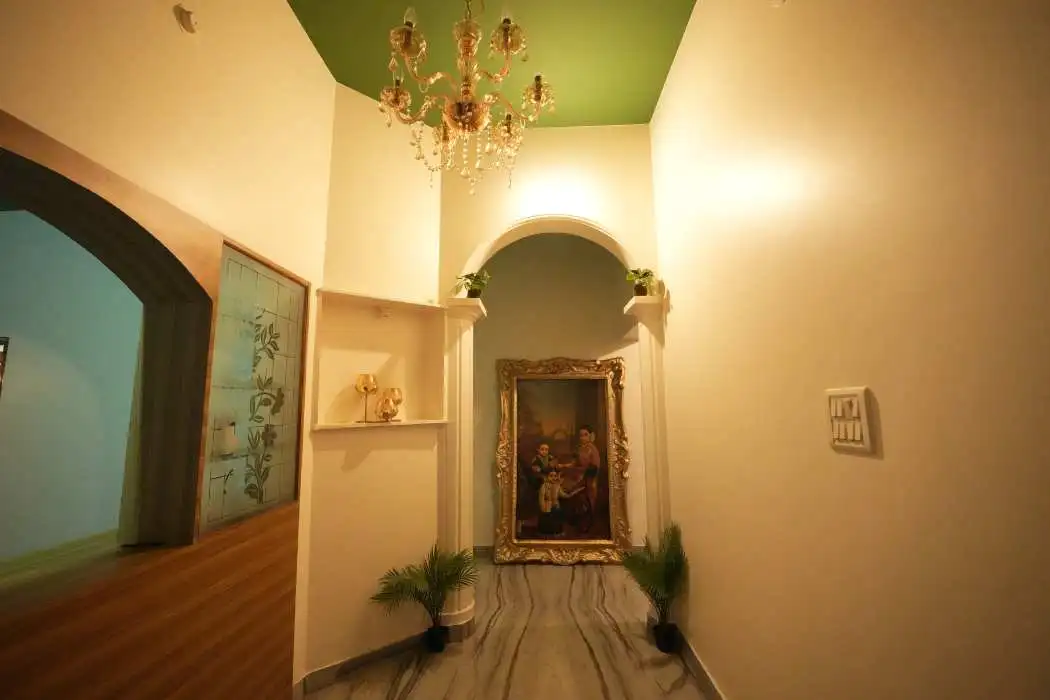 Lobby with chandelier and royal painting at Palace Hostel by Borrbo