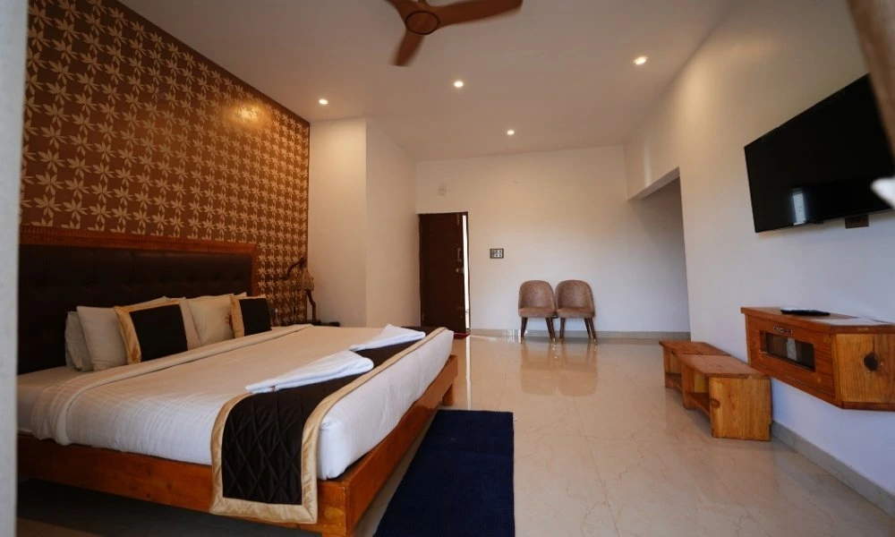 Nirvana AC room with balcony interior at Suggee Resort